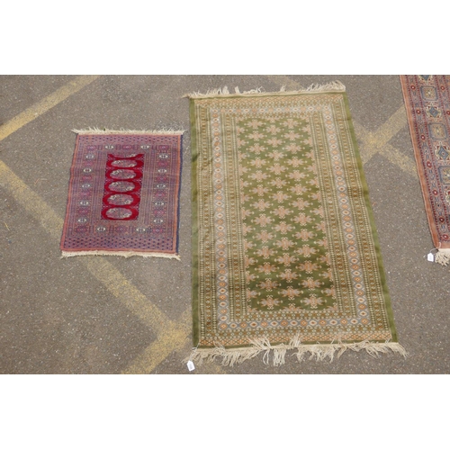 1185 - A terracotta ground wool bokhara prayer rug, and a Persian green ground wool rug with a blue and ora... 