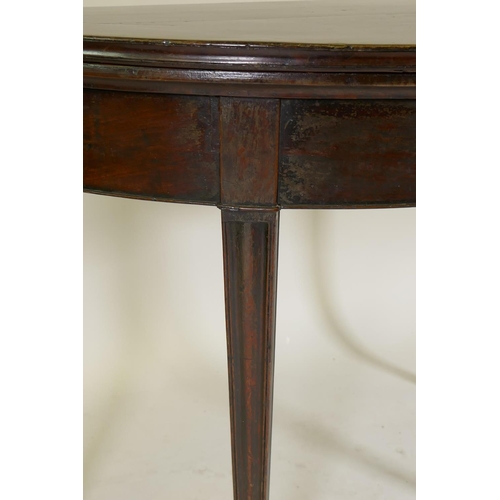 1172 - A Georgian fiddle-back mahogany demi lune card table, raised on moulded sabre supports, the base of ... 