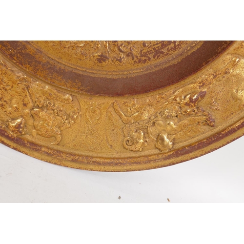 10 - A gilded cast iron wall plaque with classical decoration, 50cm diameter