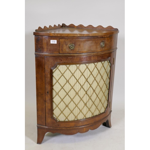 1168 - An early C20th yew wood corner cabinet with a shaped gallery and fringe, raised on swept feet, the d... 