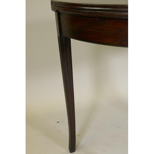 1172 - A Georgian fiddle-back mahogany demi lune card table, raised on moulded sabre supports, the base of ... 