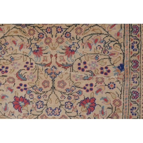 1174 - An antique Anatolian Kayseri cream ground wool rug with multi-colour all over floral design, AF wear... 