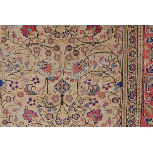 1174 - An antique Anatolian Kayseri cream ground wool rug with multi-colour all over floral design, AF wear... 