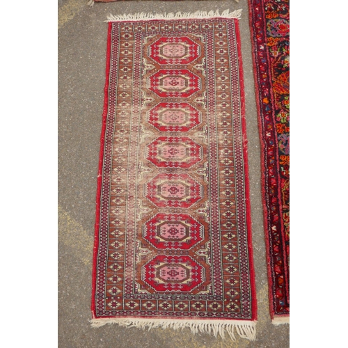 1175 - A Turkish rust ground wool rug with a medallion design, a worn red ground Bokhara runner, a deep pil... 