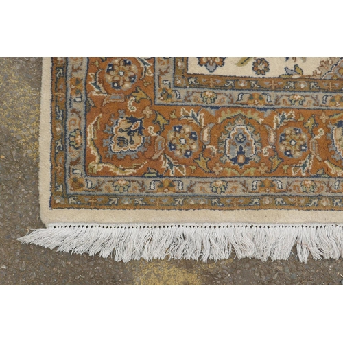 1178 - An antique cream ground deep pile wool tabriz carpet, 93