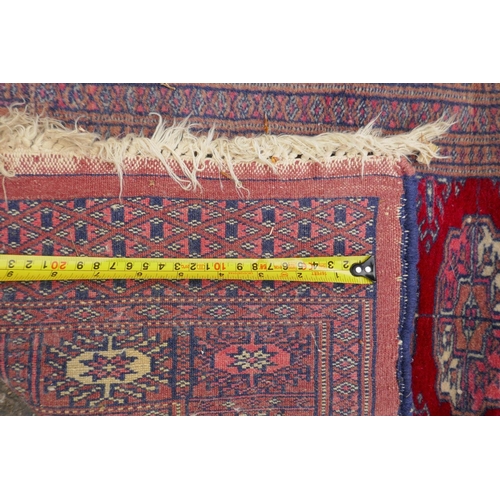 1185 - A terracotta ground wool bokhara prayer rug, and a Persian green ground wool rug with a blue and ora... 