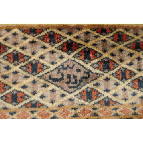 1188 - A gold ground wool Bokhara carpet, signed, 52