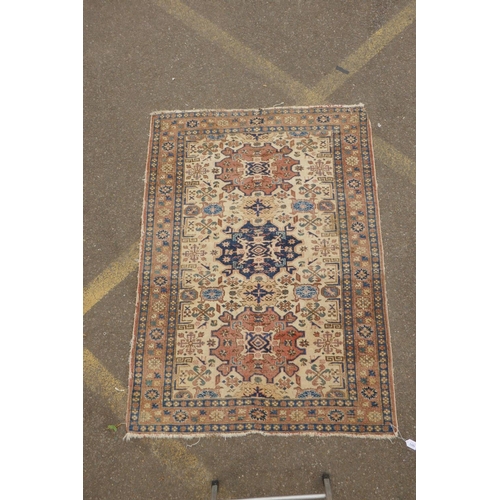 1188 - A gold ground wool Bokhara carpet, signed, 52