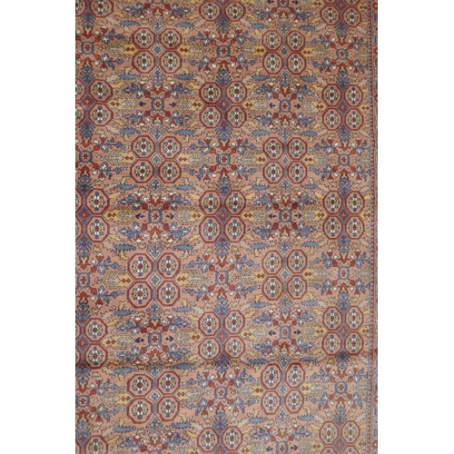 1193 - A Persian terracotta ground full pile wool carpet, decorated with an all over geometric design, 73