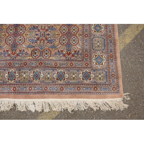 1193 - A Persian terracotta ground full pile wool carpet, decorated with an all over geometric design, 73