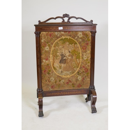 1194 - A Victorian inlaid rosewood fire screen with paw feet, fitted with a tapestry depicting a courting c... 