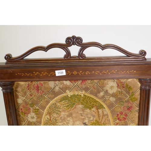 1194 - A Victorian inlaid rosewood fire screen with paw feet, fitted with a tapestry depicting a courting c... 