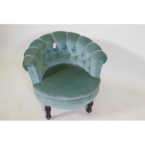 1195 - A small Victorian button back tub chair on turned supports