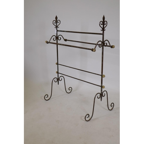 1196 - A Gothic style wrought iron towel rail with brass terminals, 40