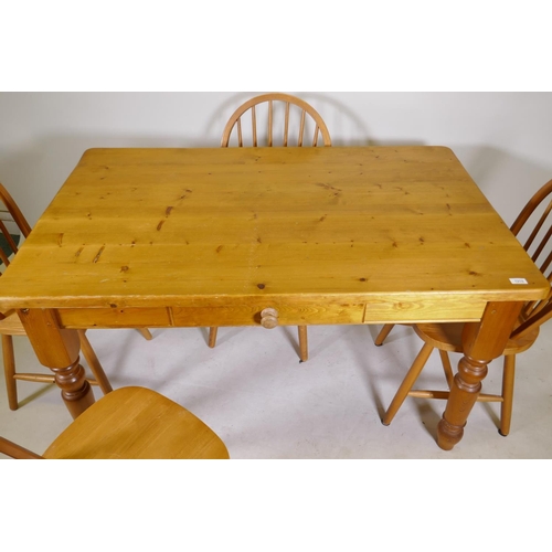 1199 - A pine kitchen table with single drawer and four hoop back beechwood chairs, 34