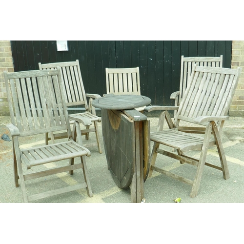 1206 - A set of four teak reclining garden armchairs, a single chair and a drop leaf table with lazy susan,... 