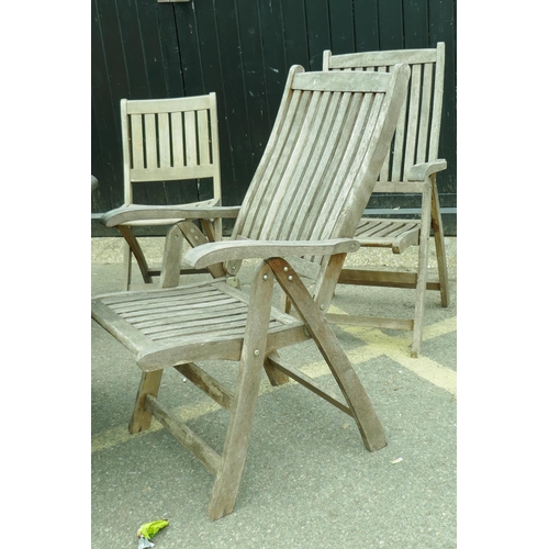 1206 - A set of four teak reclining garden armchairs, a single chair and a drop leaf table with lazy susan,... 