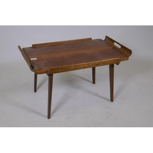 1208 - A mid century walnut serving tray with moulded handles and fold down supports, 46 x 72 x 40cm