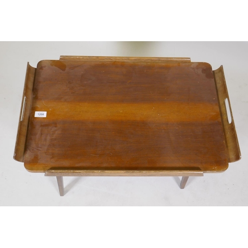 1208 - A mid century walnut serving tray with moulded handles and fold down supports, 46 x 72 x 40cm