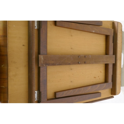 1208 - A mid century walnut serving tray with moulded handles and fold down supports, 46 x 72 x 40cm