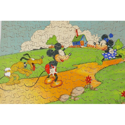 23 - A 1930s Chad Valley wooden Mickey Mouse jigsaw puzzle, and a Parker Brothers clock, Tiddley Winks bo... 