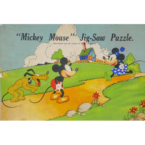 23 - A 1930s Chad Valley wooden Mickey Mouse jigsaw puzzle, and a Parker Brothers clock, Tiddley Winks bo... 