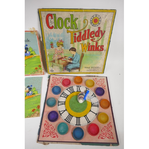 23 - A 1930s Chad Valley wooden Mickey Mouse jigsaw puzzle, and a Parker Brothers clock, Tiddley Winks bo... 