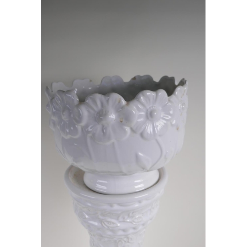 39 - A German white glazed pottery jardiniere on stand with embossed flower and vine decoration, 67cm hig... 