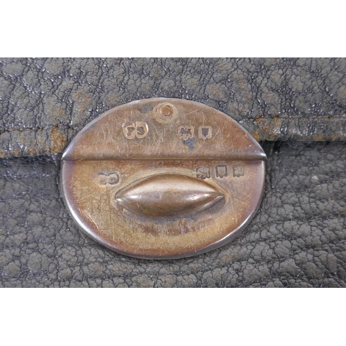 42 - An antique silver mounted leather hand bag, London 1916, a silver mounted leather purse, London 1922... 