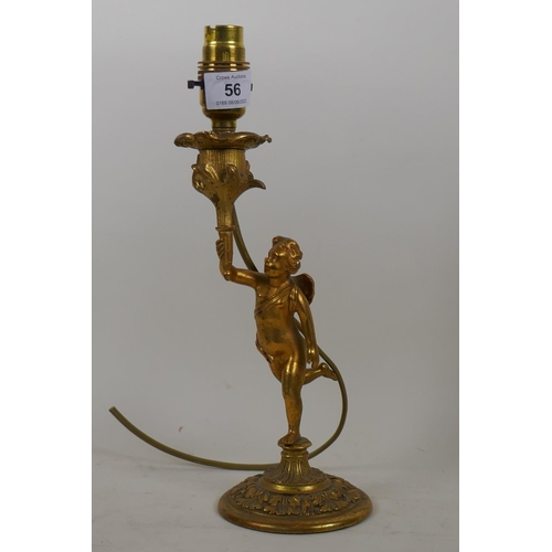 56 - A brass table lamp in the form of a putto bearing a torchere, 24cm high