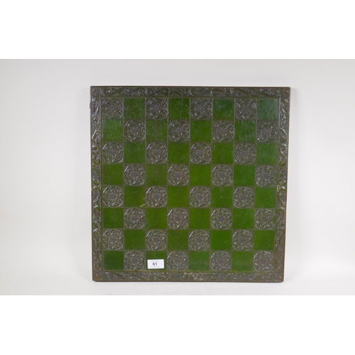 61 - A carved and lacquered chess board with tudor rose decoration, 46cm x 46cm