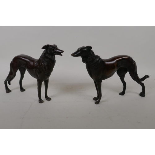 68 - A pair of bronze figures of hounds, 27cm long