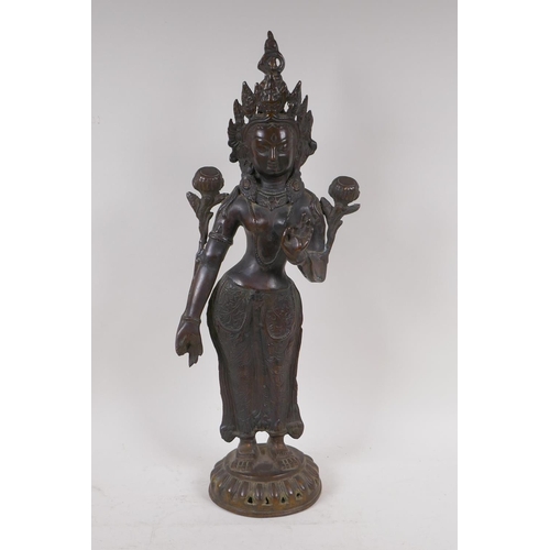 69 - An antique bronze figure of Shiva, standing upon a dais, 50cm high