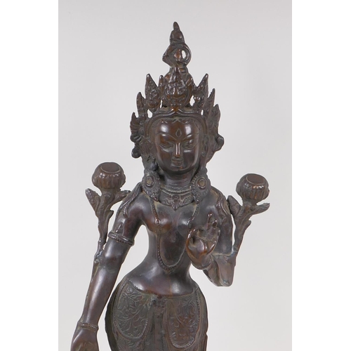 69 - An antique bronze figure of Shiva, standing upon a dais, 50cm high