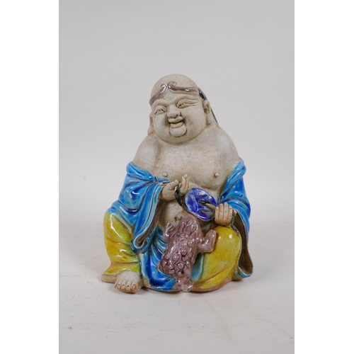 70 - A Chinese Sancai glazed porcelain Lohan figure, 17cm high