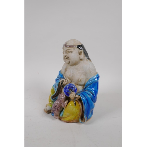 70 - A Chinese Sancai glazed porcelain Lohan figure, 17cm high