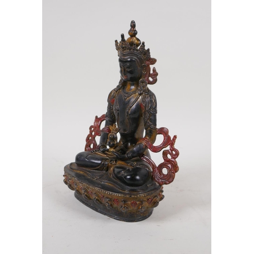 71 - A Sino Tibetan bronze figure of Buddha with gilt and coppered patina, 21cm high