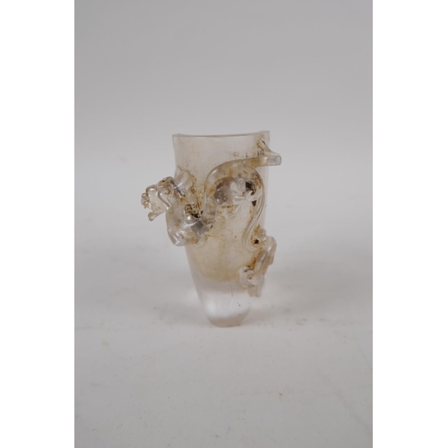 73 - A Chinese moulded glass libation cup with climbing kylin decoration, 9cm high