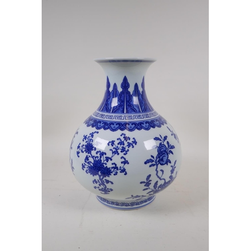 74 - A blue and white porcelain vase decorated with flowers and fruiting peach and pomegranate trees, Chi... 