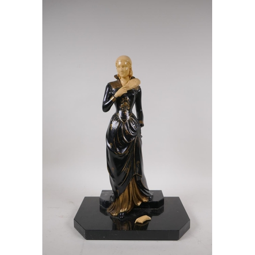 76 - An Art Deco style cold painted bronze figure of a woman with feather fan, on a polished stone base, ... 