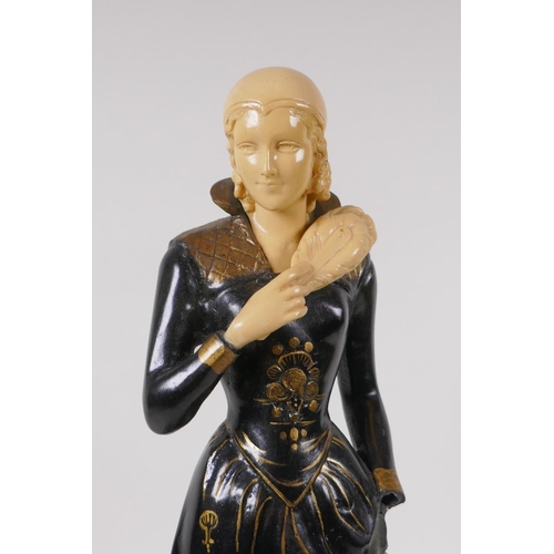 76 - An Art Deco style cold painted bronze figure of a woman with feather fan, on a polished stone base, ... 