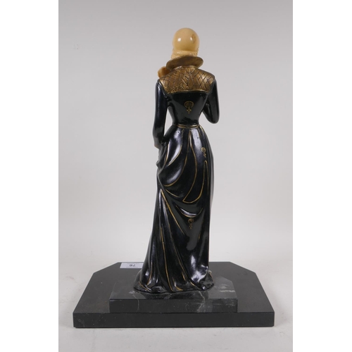 76 - An Art Deco style cold painted bronze figure of a woman with feather fan, on a polished stone base, ... 