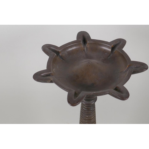 8 - An antique Indian bronze incense burner with shaped top and ring turned column, 39cm high