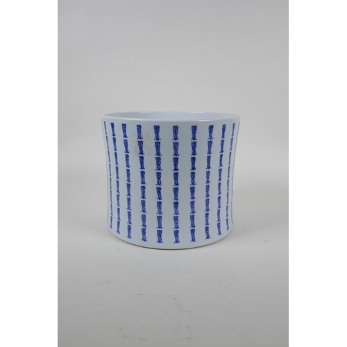 21 - A blue and white brush pot of waisted form, with all over Chinese seal mark decoration, 17cm high x ... 