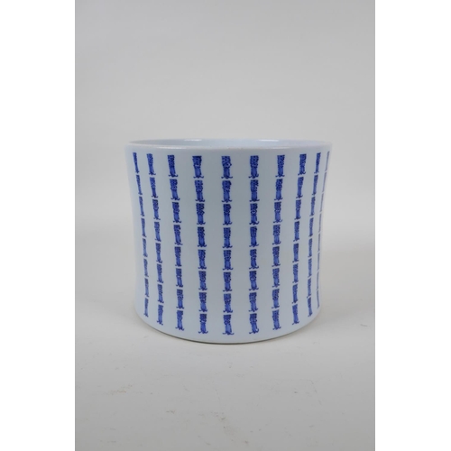 21 - A blue and white brush pot of waisted form, with all over Chinese seal mark decoration, 17cm high x ... 