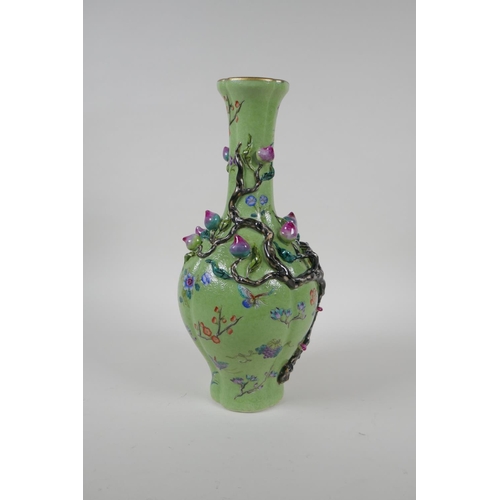 37 - A polychrome porcelain vase with raised peach tree decoration on a green ground, Chinese Qianlong se... 