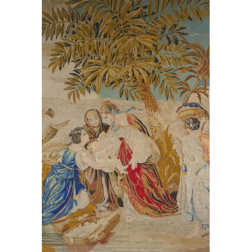 84 - A C19th needlework tapestry panel depicting Moses and the Pharoah's daughter at the river's edge, in... 