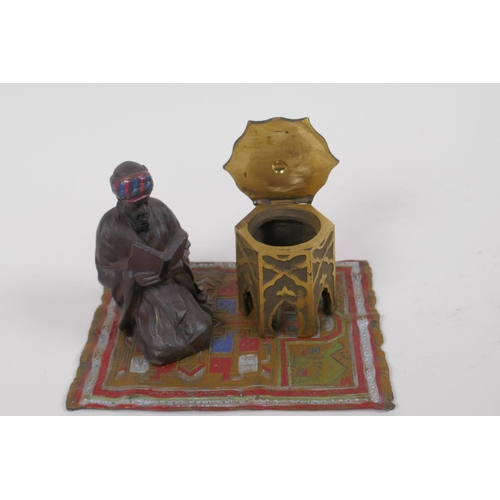 10 - A cold painted bronze inkwell cast as an Arab gentleman kneeling on a rug, 14.5cm