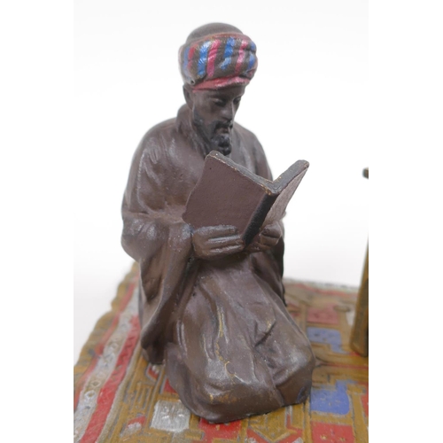 10 - A cold painted bronze inkwell cast as an Arab gentleman kneeling on a rug, 14.5cm