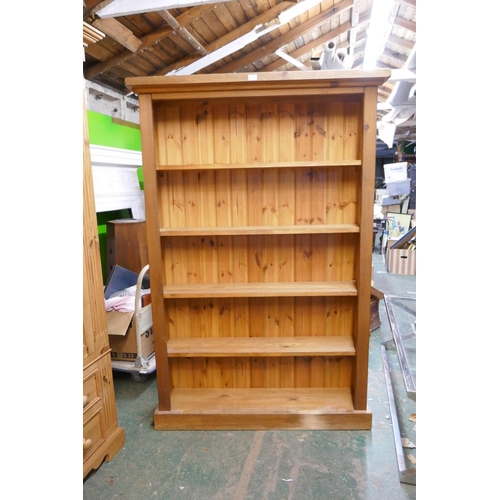 1170 - A pine open bookcase on a plinth base, 121 x 31cm, 182cm high